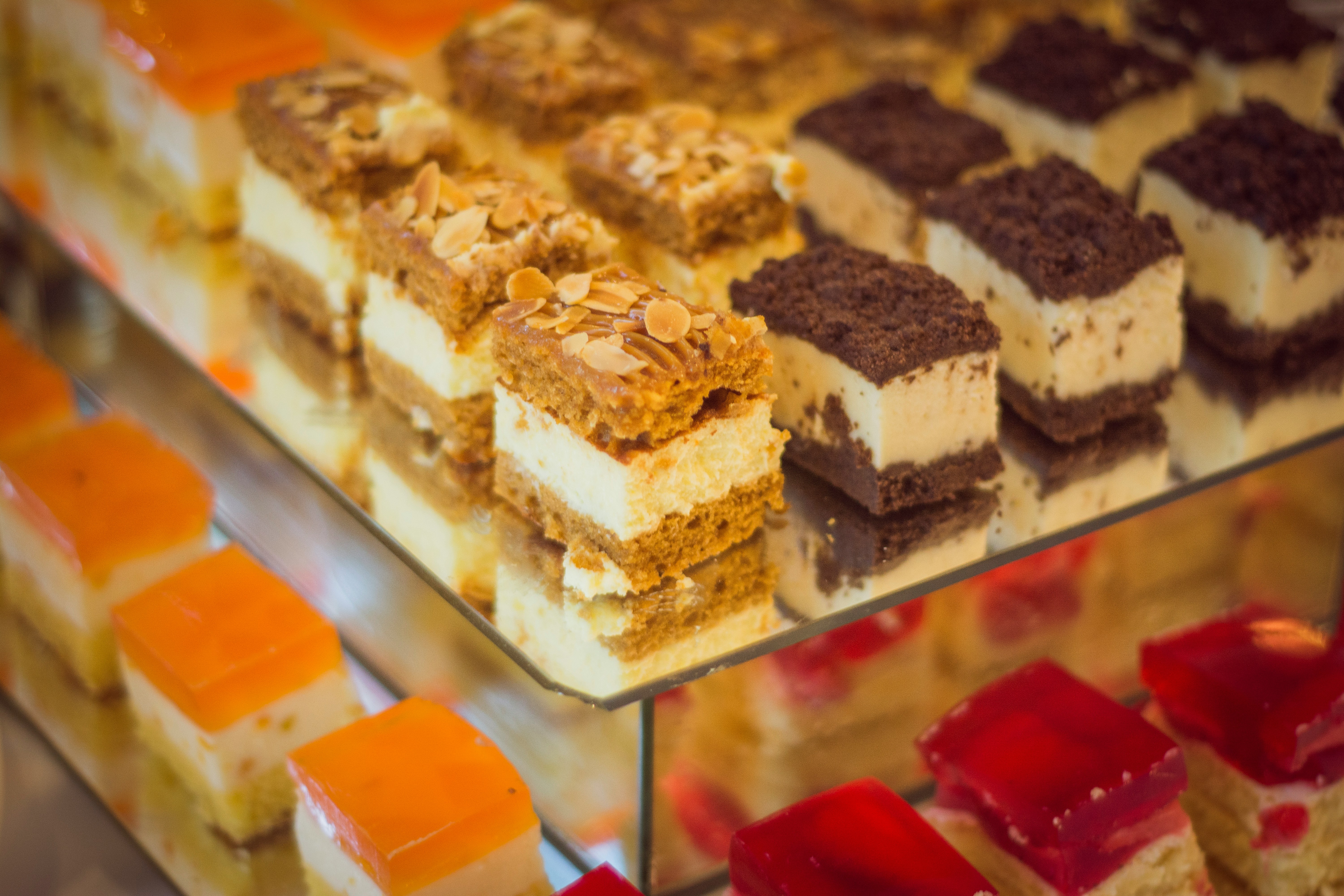 Assortment of traditional Indian sweets including Mysore Pak, Ladoo, and Mixture from The Grand Sweets & Snacks